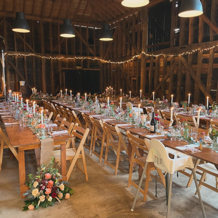 Long table dressed & set for large group.